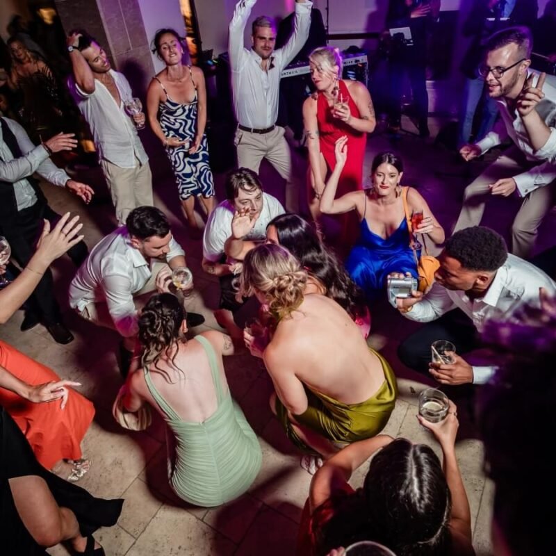Wedding party with guests dancing to a live wedding band in Spain