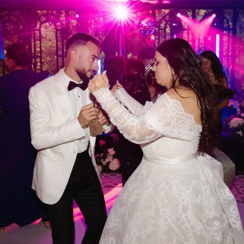 Destination wedding band in Spain with bride and groom dancing during the party